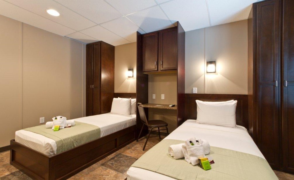 Man Using Measuring Tape in Factory Setting Man Using Measuring Tape in Factory Setting